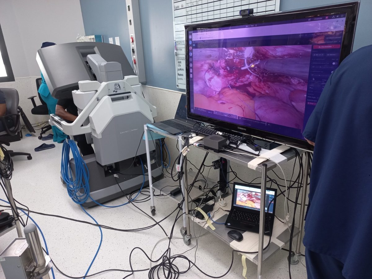 Telementoring platform on a large screen next to a da Vinci SimNow console