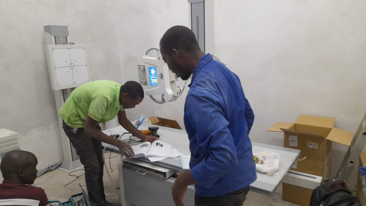 Two engineers installing an X-ray machine